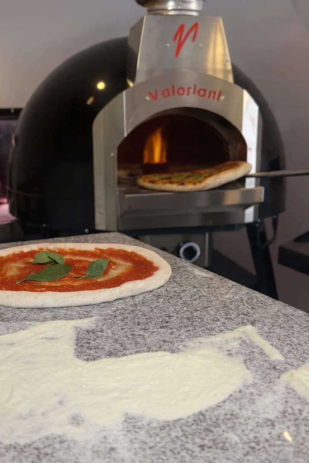 Interior view of At Piotsa food truck showing authentic Italian pizza preparation area and oven
